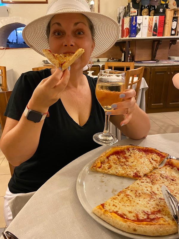 Melissa enjoying pizza and sparkling wine in Italy
