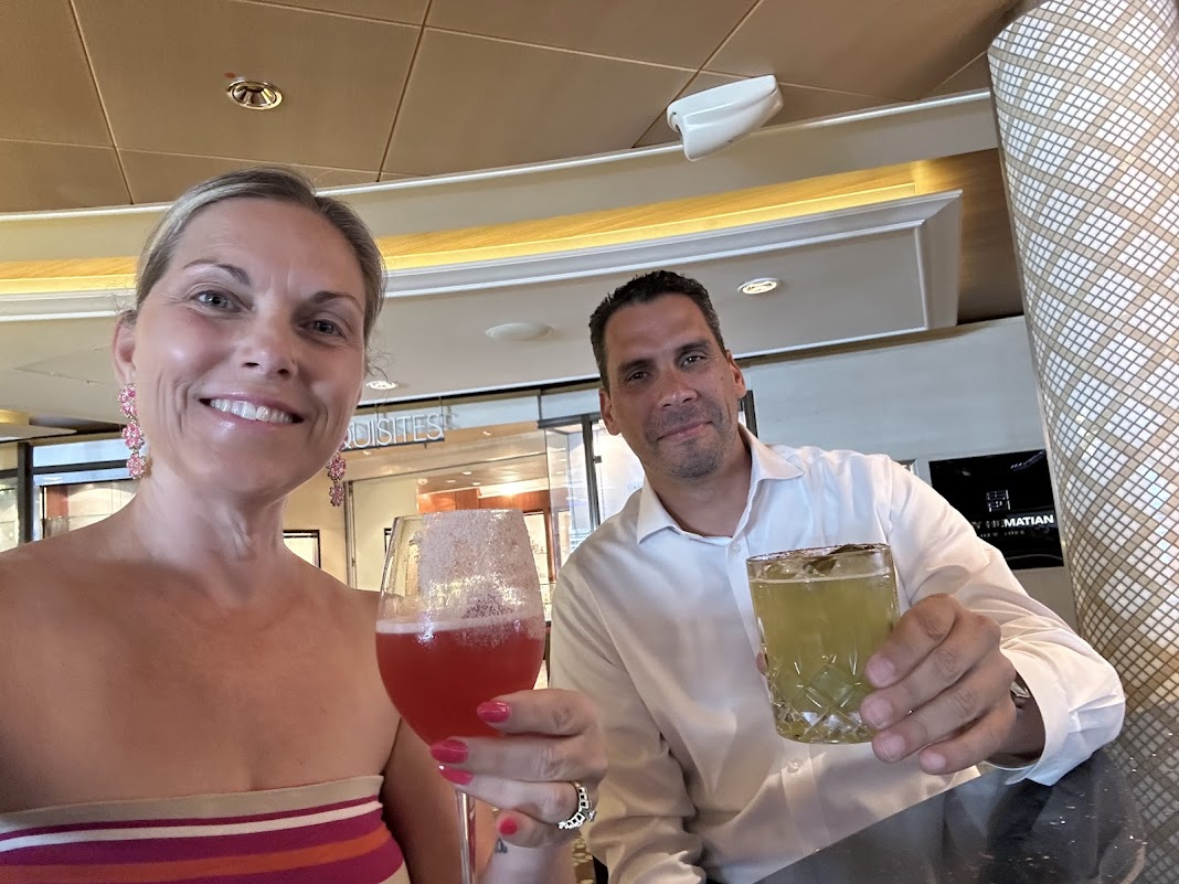 Melissa and her husband toasting with cocktails onboard the Celebrity Eclipse