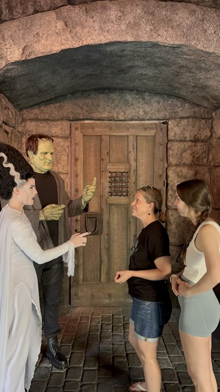Melissa meeting Frankenstein and the Bride of Frankenstein at Dark Universe in Epic Universe