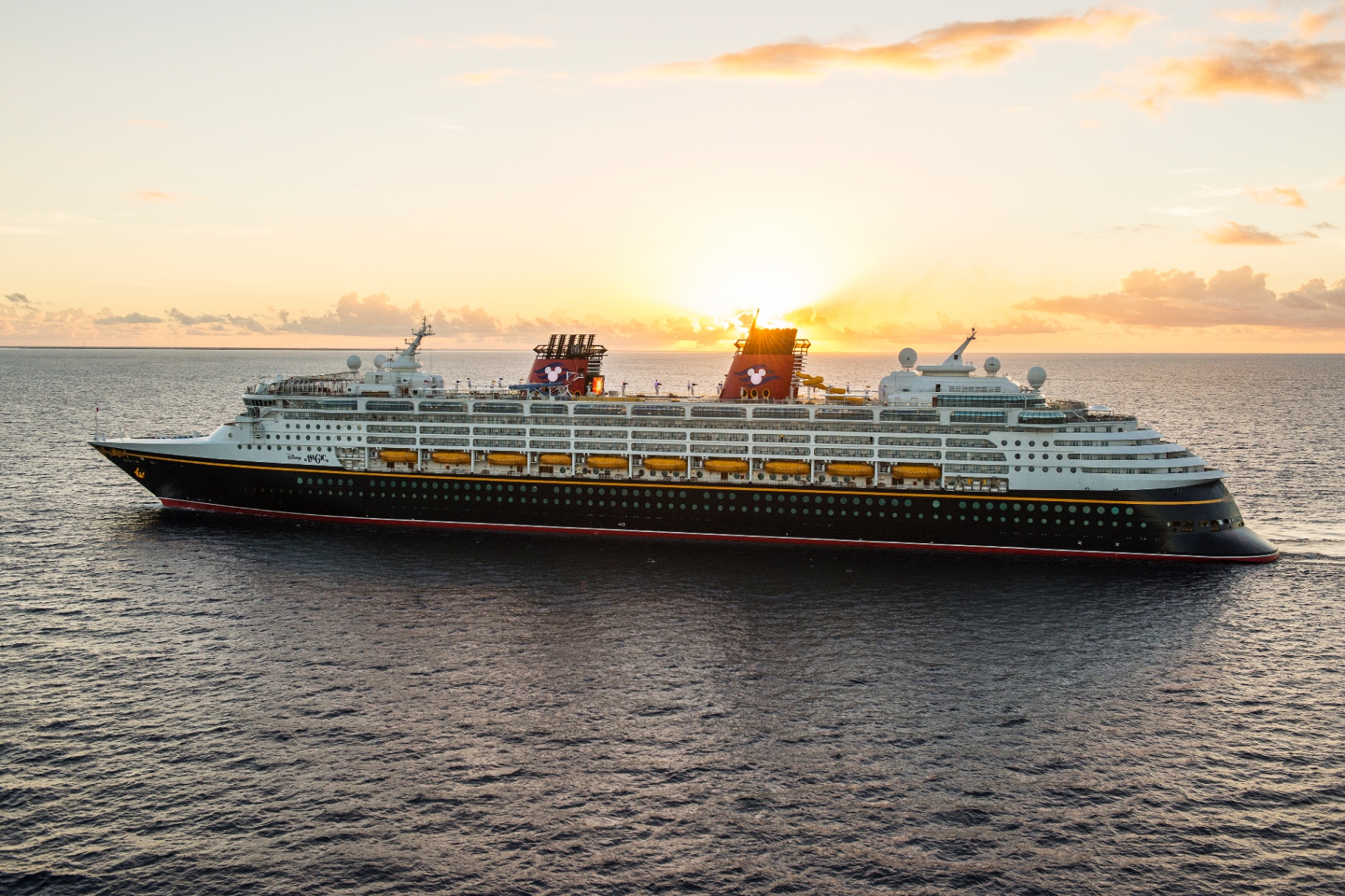 Disney Magic cruise ship at sea during sunset
