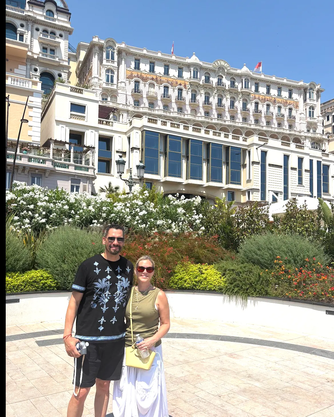 Melissa and her husband in front of a grand hotel on the French Riviera