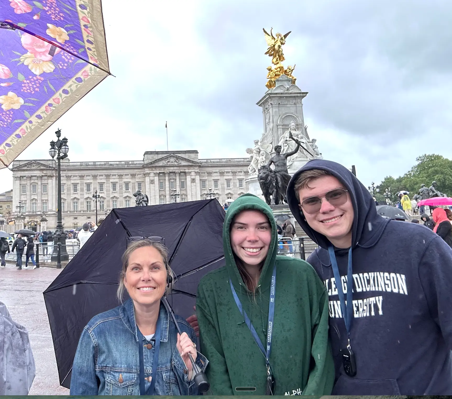 Melissa and her two children outside Buckingham Palace in London on a rainy day