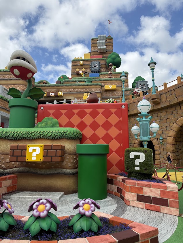 Colorful Mushroom Kingdom scenery with question blocks and a Piranha Plant at Super Nintendo World