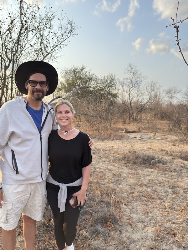 On safari in South Africa with a cheetah resting in the background